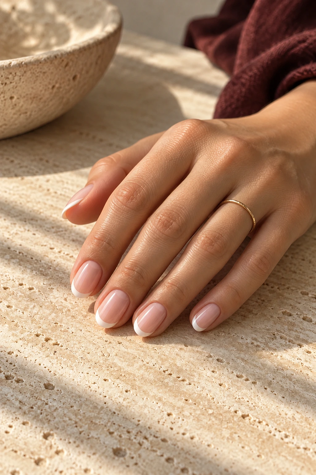 Sheer pink nails with delicate white French tips
